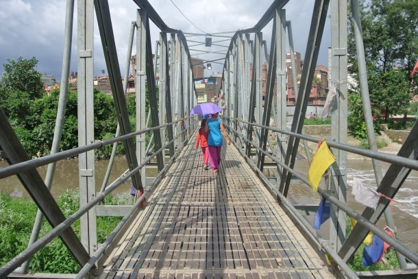 Crossing a bridge by the Monkey Temple--everyone carried umbrellas in the valley for all the sun.