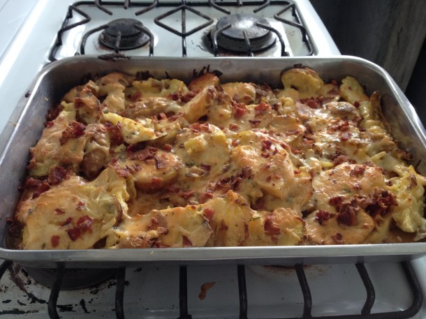 Adding bacon to the scalloped potatoes.